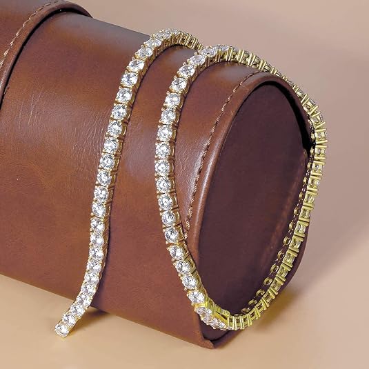 Gold and silver bracelet on a brown leather surface