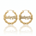 Gold hoop earrings with 'Babycity' engraving on a white background