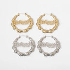 Four pairs of hoop earrings in gold and silver on a white background