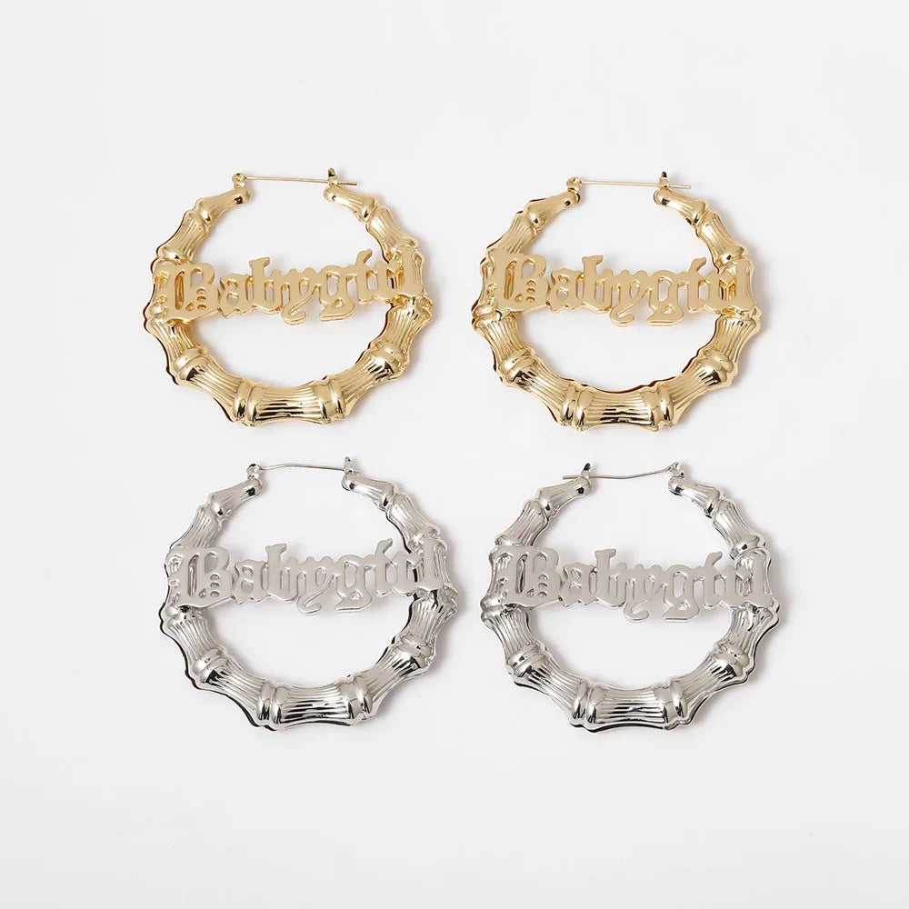 Four pairs of hoop earrings in gold and silver on a white background