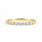 Gold ring with small diamonds on a white background