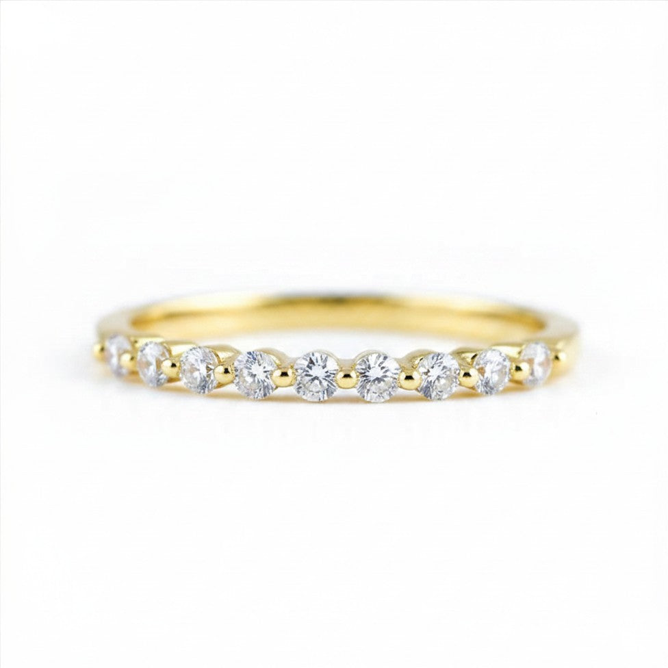 Gold ring with small diamonds on a white background