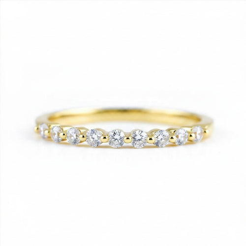 Gold ring with small diamonds on a white background