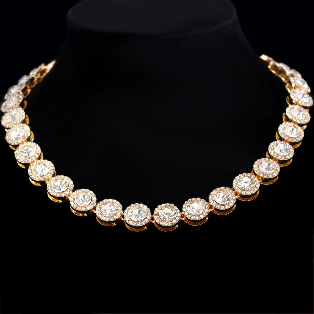 Gold necklace with clear stones on a black background