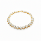 Gold Necklace with clear gemstones on a white background