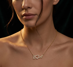 Close-up of a woman wearing a gold necklace with a 'love' pendant against a dark background
