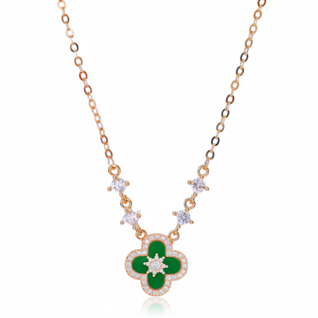 Gold necklace with a green clover pendant on a white background
