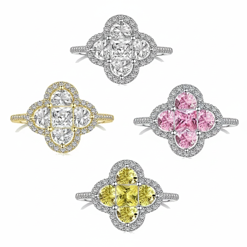 Four diamond rings with different colored center stones on a white background