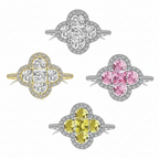 Four diamond rings with different colored center stones on a white background