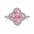 Ring with pink gemstones and silver accents on a white background