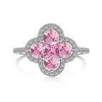 Ring with pink gemstones and silver accents on a white background