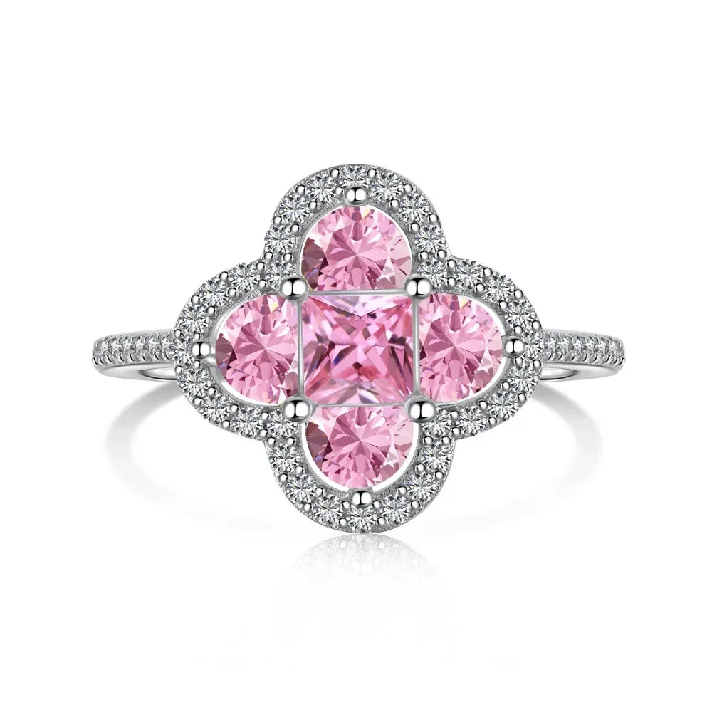 Ring with pink gemstones and silver accents on a white background