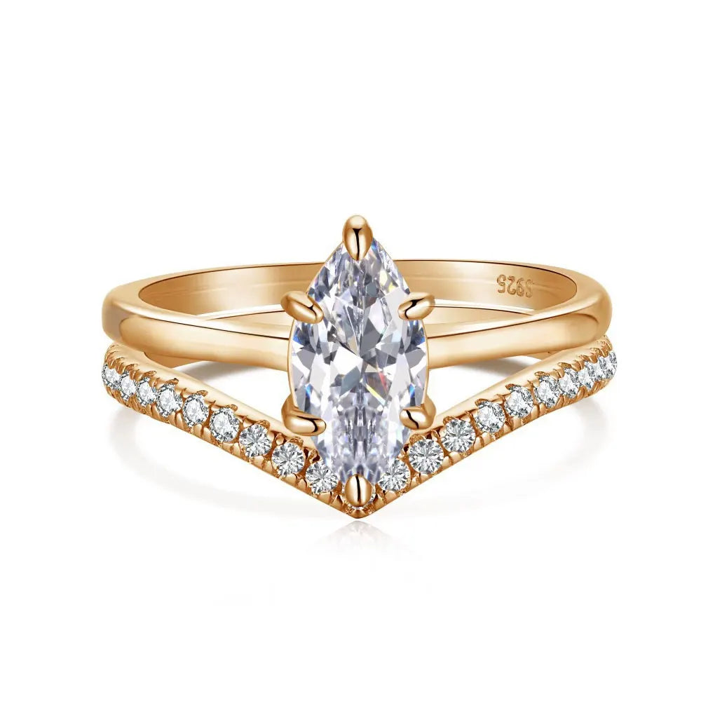 Rose gold ring with a pear-shaped diamond and smaller diamonds on a white background