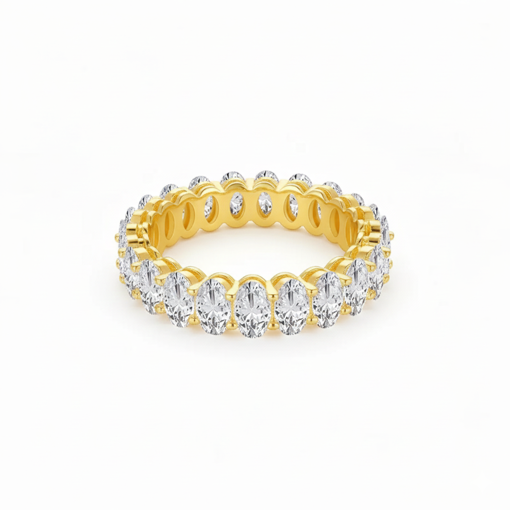 Gold ring with clear gemstones on a white background
