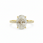 Gold ring with a large diamond and smaller diamonds on the band against a white background