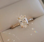 Rose gold diamond ring on a light gray surface
