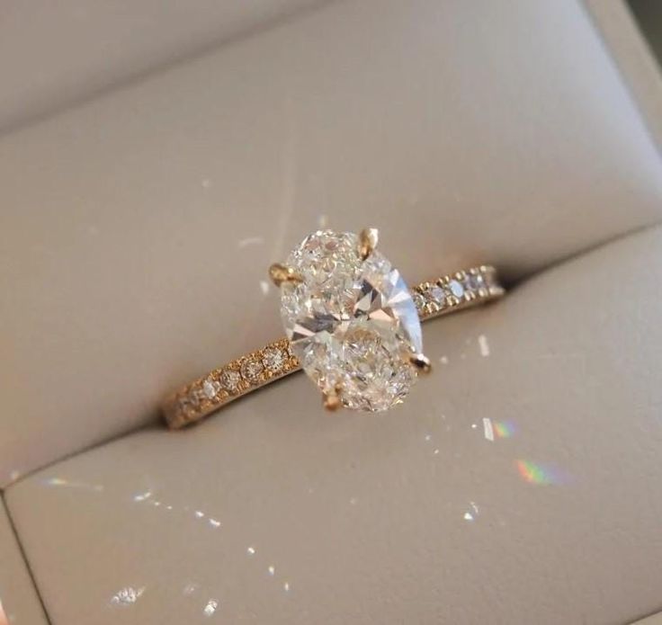 Rose gold diamond ring on a light gray surface