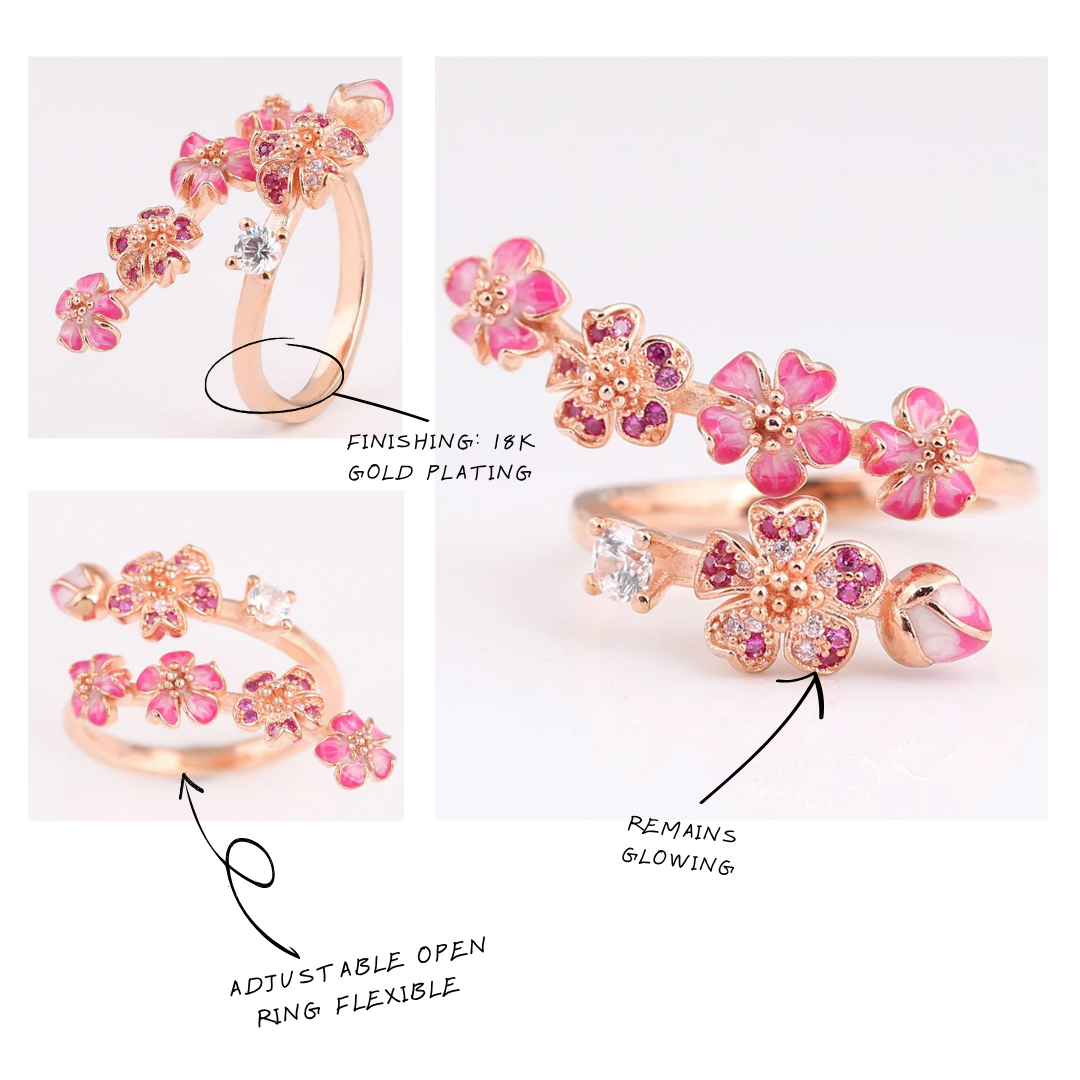 Floral ring with pink gemstones and gold plating, shown on a white background.