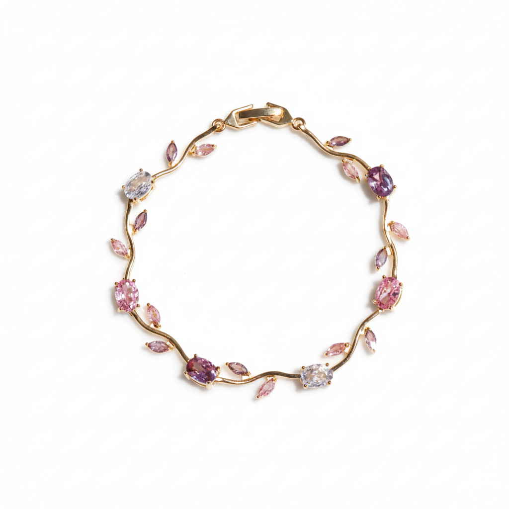 Gold bracelet with pink gemstones on a white background