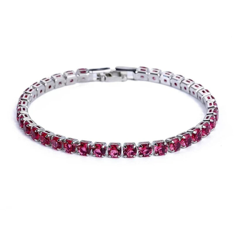 Silver bracelet with red gemstones on a white background