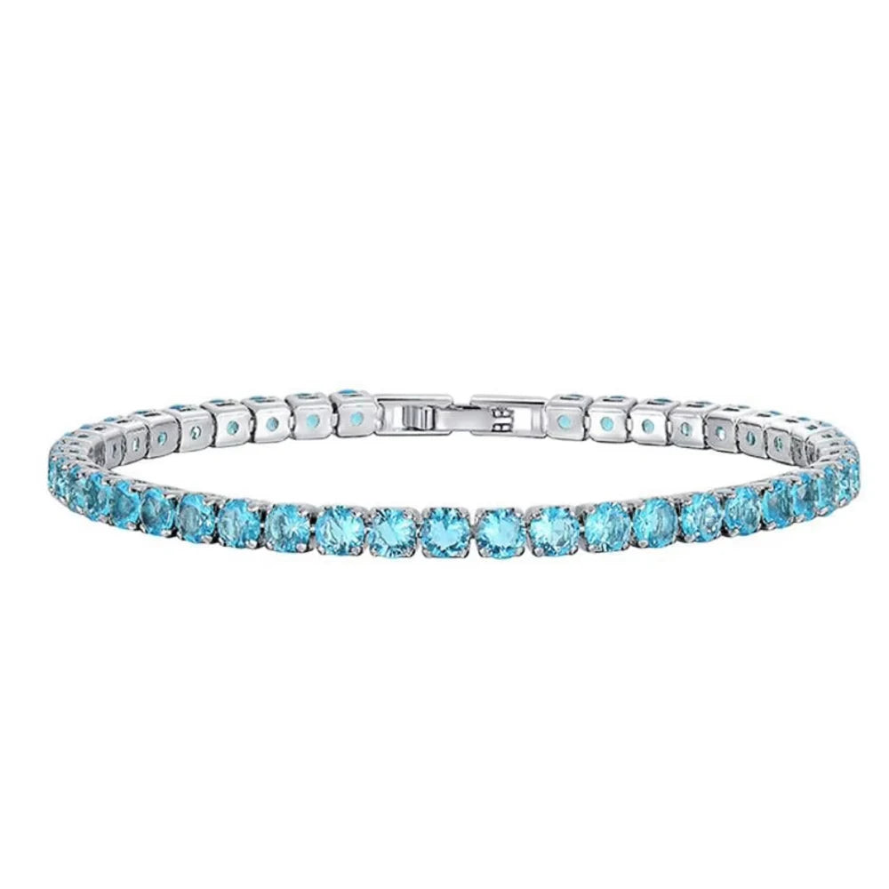 Silver bracelet with blue gemstones on a white background