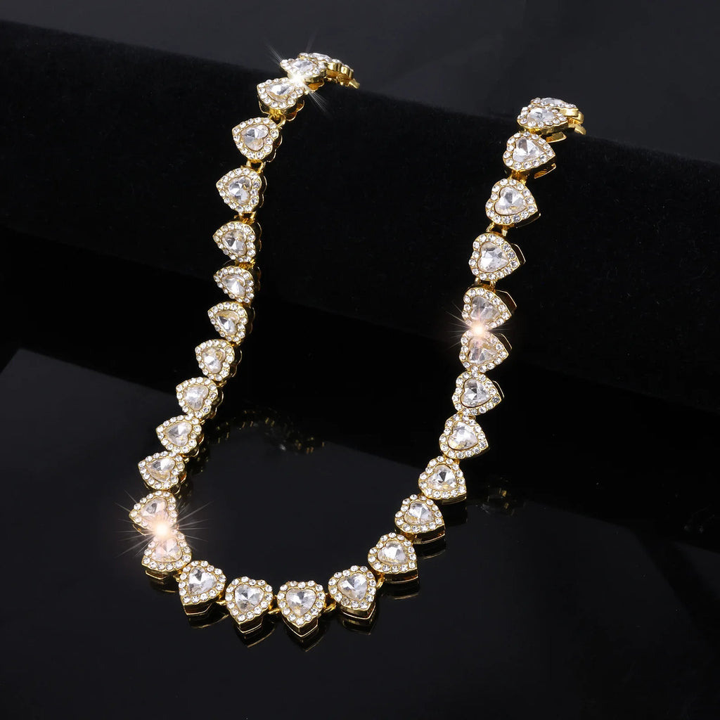 Gold necklace with heart-shaped diamonds on a black background