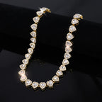 Gold necklace with heart-shaped diamonds on a black background