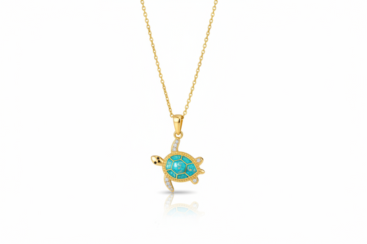 Gold turtle pendant necklace with turquoise stone on a white background