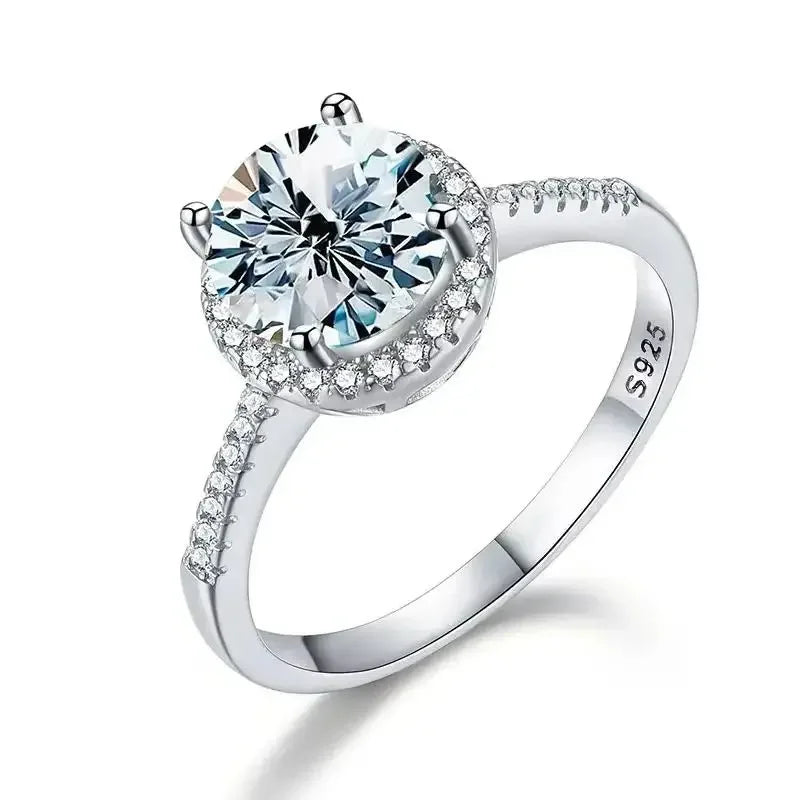 Silver ring with a large central gemstone on a white background