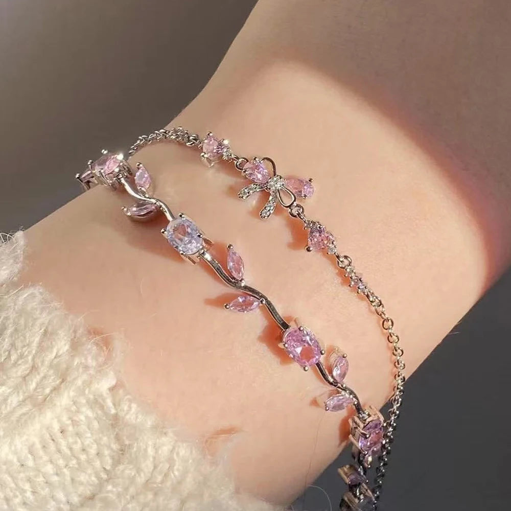 Bracelet with pink gemstones on a wrist against a neutral background