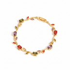Gold bracelet with multicolored gemstones on a white background