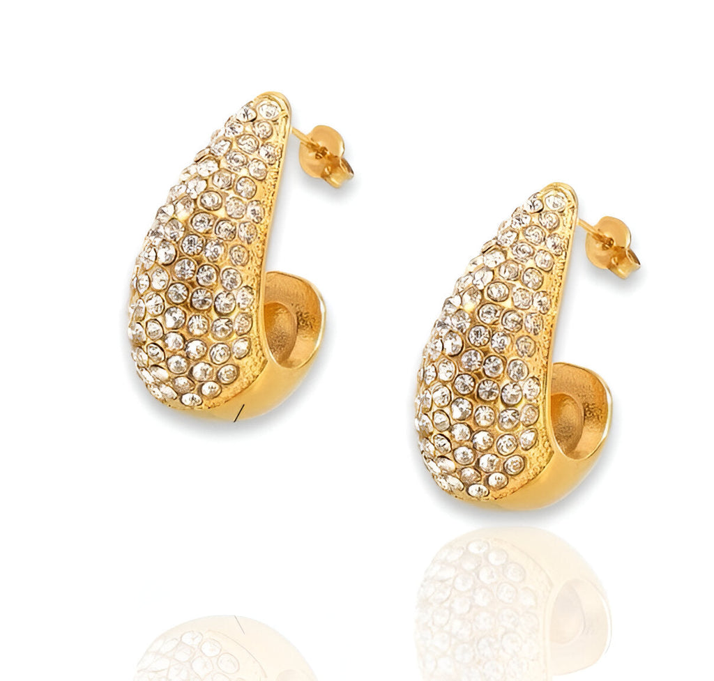 Gold hoop earrings with crystal embellishments on a white background