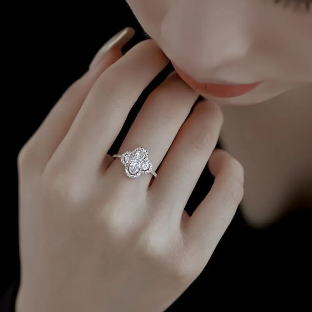 Close-up of a hand wearing a diamond ring with a dark background